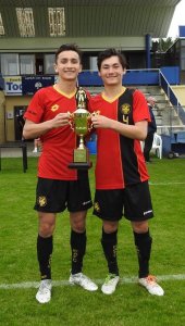 Sam and Denny hold the trophy after the final
